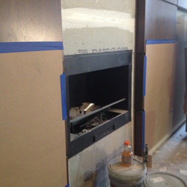 A closeup view of the indoor fire pit during construction.