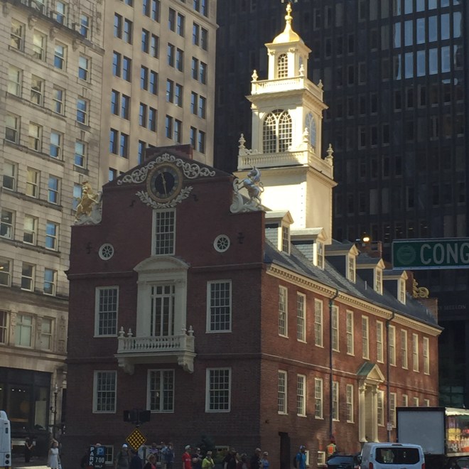 At the corner of Washington and State streets, you'll see the Old State House, which is a historic building in Boston.